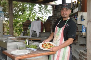 A cook displaying a pizza | business Photographer Trenton, Ontario