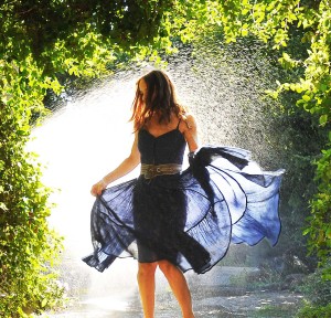 A woman dancing in a sprinkler | Portrait Photographer Trenton, Ontario